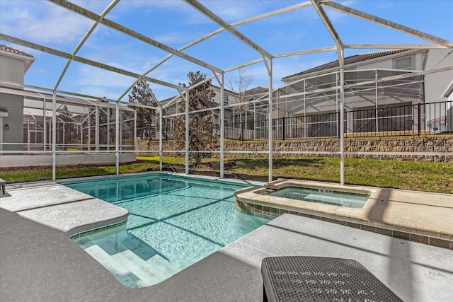 view of pool with a lanai and an in ground hot tub