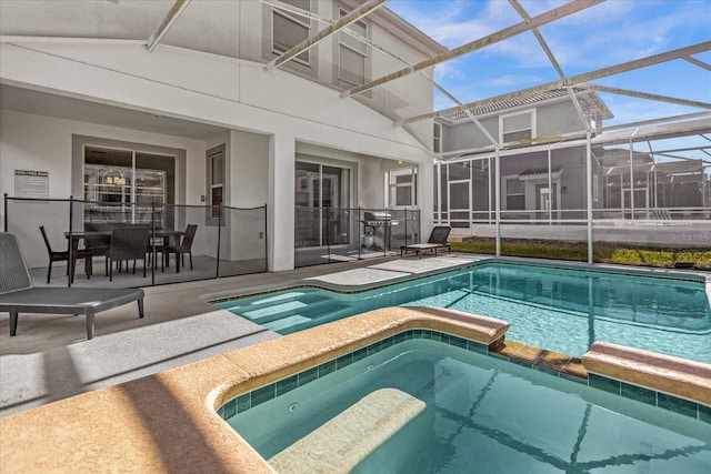 view of pool featuring a patio and glass enclosure