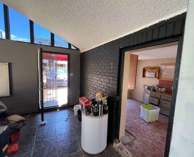 interior space with high vaulted ceiling and a textured ceiling