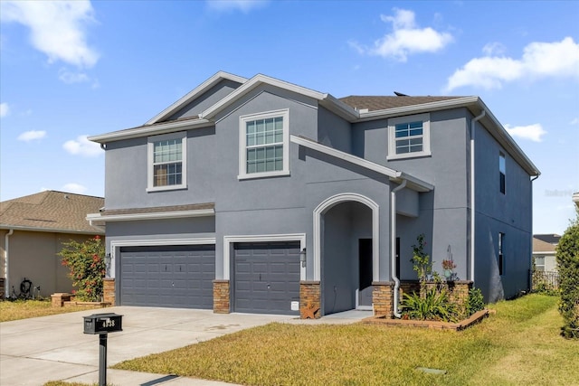 view of property featuring a front lawn and a garage