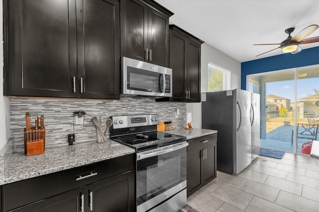 kitchen with ceiling fan, light stone counters, decorative backsplash, light tile patterned floors, and appliances with stainless steel finishes