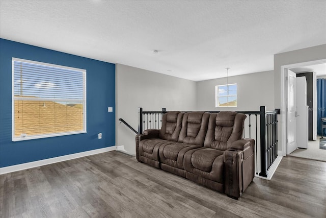 living room with dark hardwood / wood-style flooring and a textured ceiling