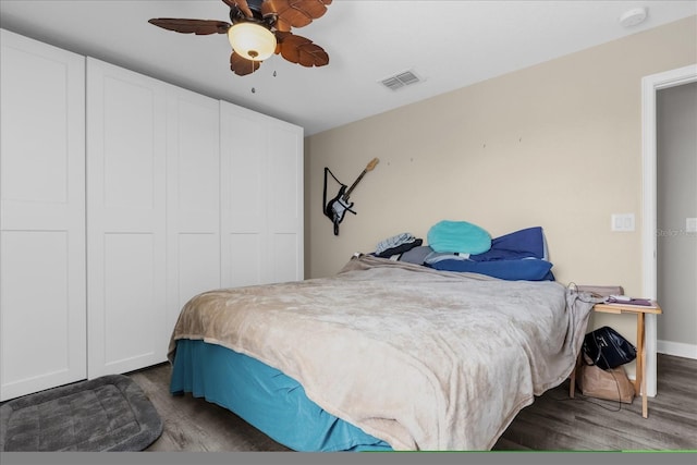 bedroom featuring ceiling fan and dark hardwood / wood-style floors