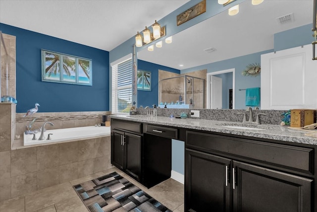 bathroom with tile patterned flooring, vanity, and shower with separate bathtub