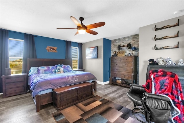 bedroom with ceiling fan and dark wood-type flooring