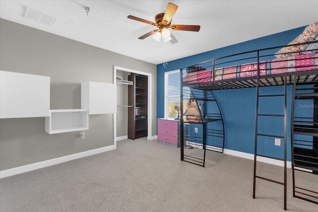 unfurnished bedroom with light carpet, a closet, and ceiling fan