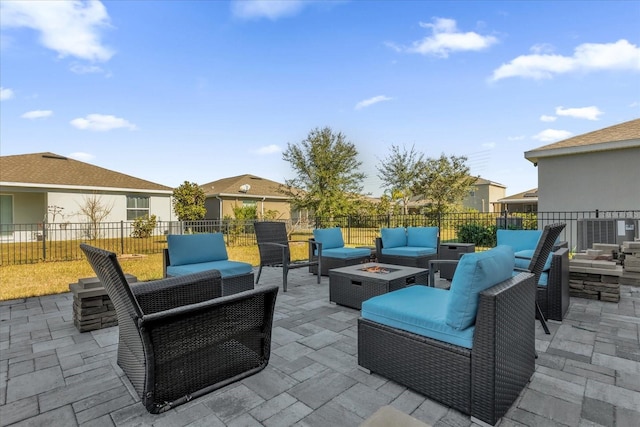 view of patio featuring an outdoor living space with a fire pit