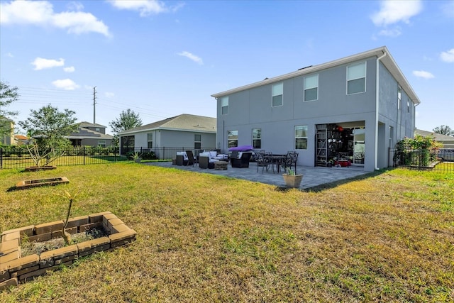 rear view of property with a patio area, outdoor lounge area, and a yard