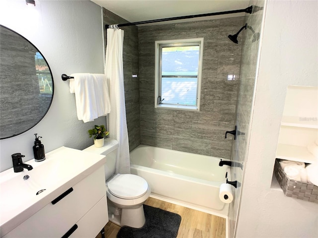 full bathroom featuring hardwood / wood-style floors, vanity, shower / bath combination with curtain, and toilet