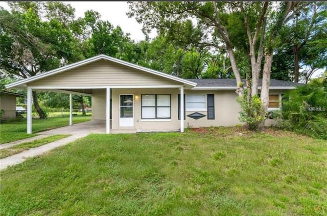 ranch-style home with a front yard and a carport