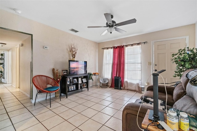 living room with ceiling fan and light tile patterned floors