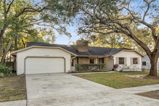 single story home with a front yard and a garage