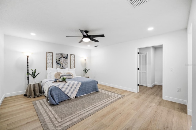 bedroom with ceiling fan and light hardwood / wood-style flooring