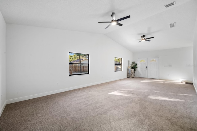 spare room with ceiling fan, vaulted ceiling, and carpet floors