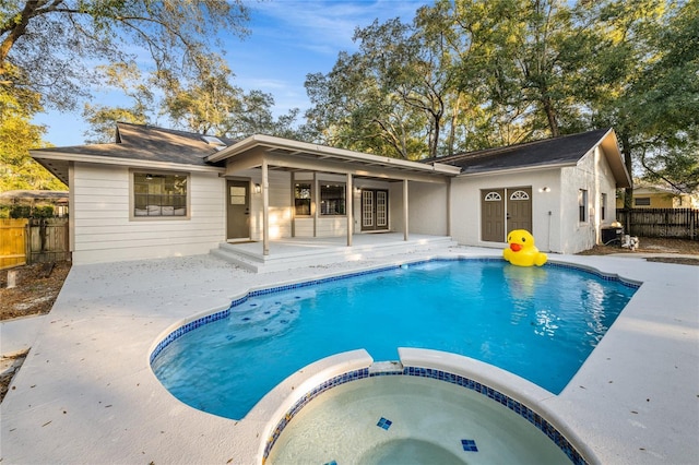 view of pool with an in ground hot tub and a patio area