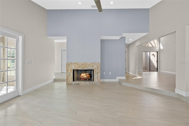 unfurnished living room with a fireplace and light tile patterned floors