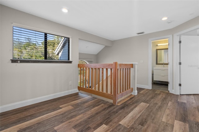 hall featuring dark hardwood / wood-style floors and lofted ceiling