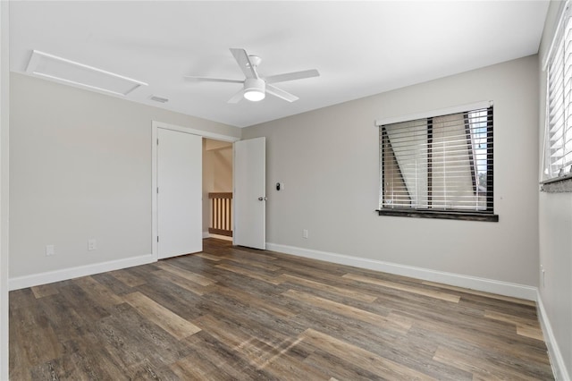 unfurnished room with ceiling fan and dark wood-type flooring