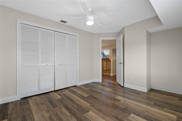 unfurnished bedroom featuring a closet, ceiling fan, and dark wood-type flooring