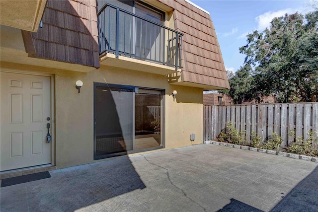 exterior space with a balcony and a patio