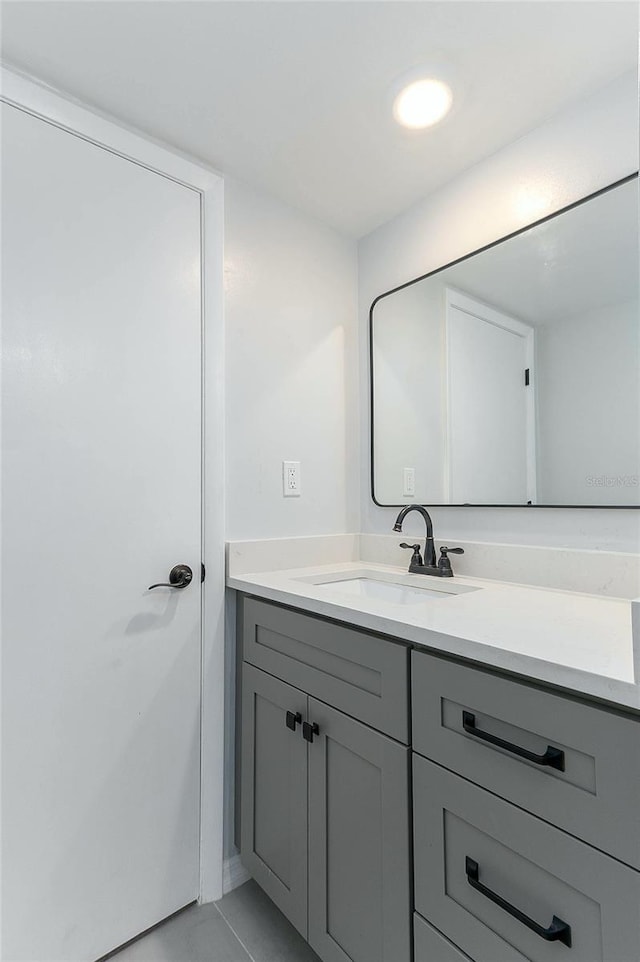 bathroom with tile patterned flooring and vanity