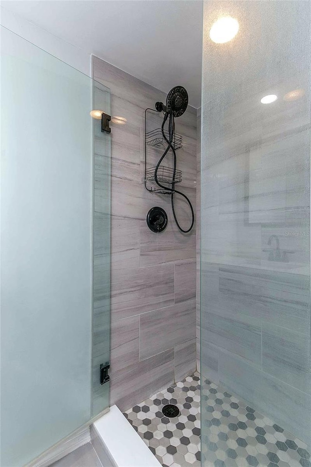 bathroom with a shower with shower door