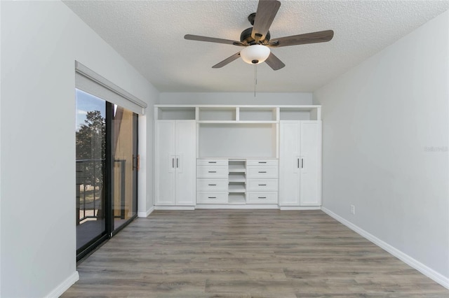 unfurnished bedroom featuring ceiling fan, hardwood / wood-style floors, a textured ceiling, access to outside, and a closet