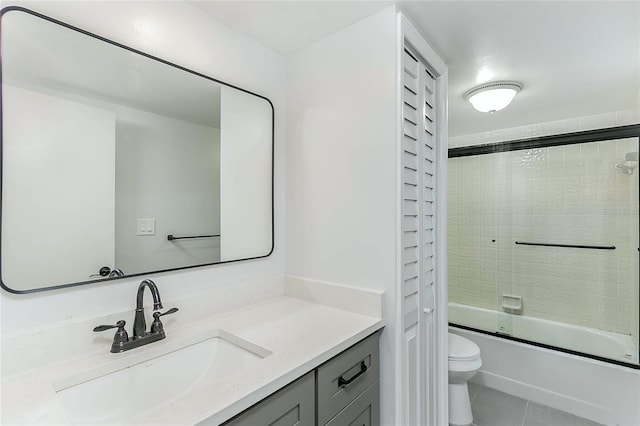 full bathroom with tile patterned flooring, vanity, toilet, and enclosed tub / shower combo