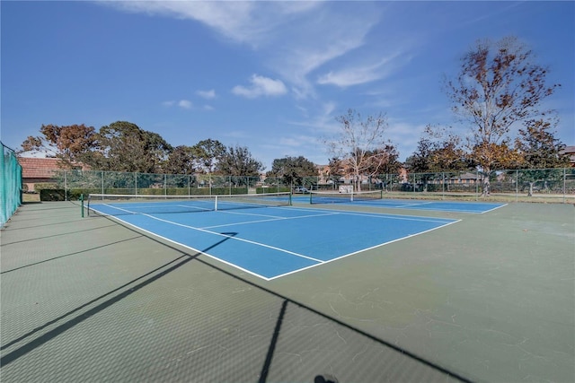 view of tennis court featuring basketball hoop