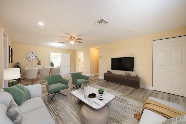 living room with ceiling fan and wood-type flooring