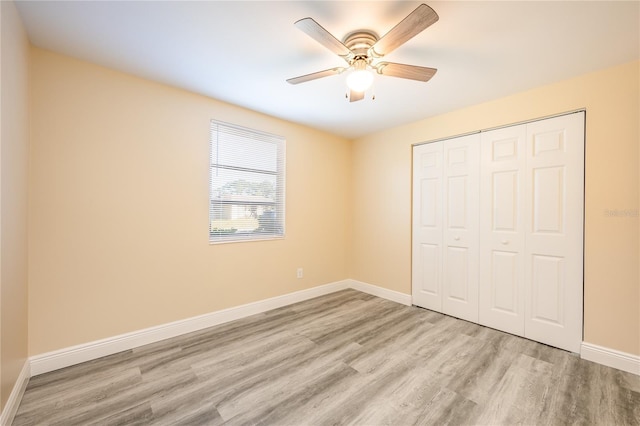 unfurnished bedroom with ceiling fan, light hardwood / wood-style floors, and a closet