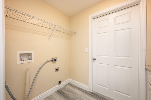 laundry room with hookup for a washing machine, light hardwood / wood-style flooring, and hookup for an electric dryer