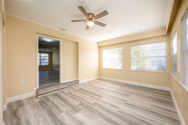 unfurnished room with ceiling fan and light wood-type flooring