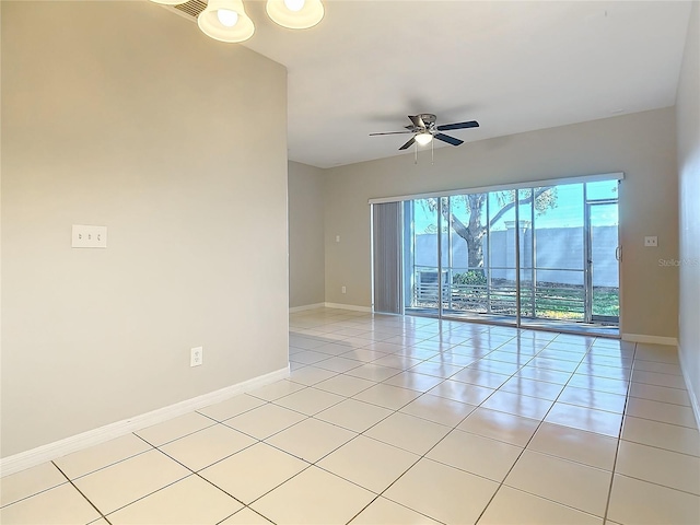 tiled spare room with ceiling fan