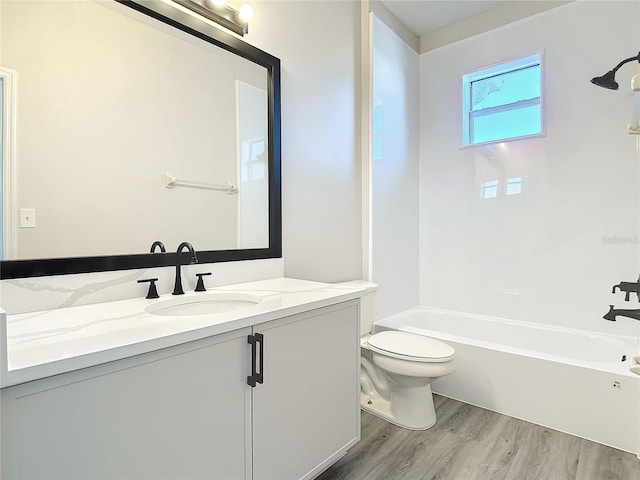 full bathroom with shower / bathing tub combination, vanity, toilet, and wood-type flooring