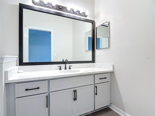 bathroom with hardwood / wood-style floors and vanity