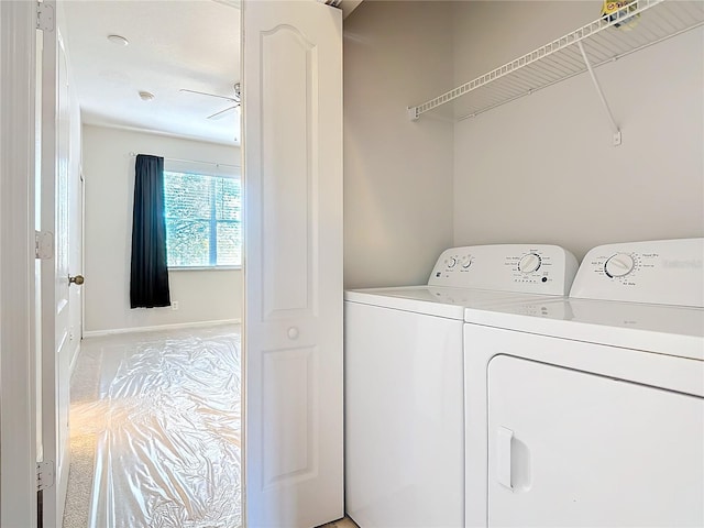 washroom featuring light carpet and washer and clothes dryer