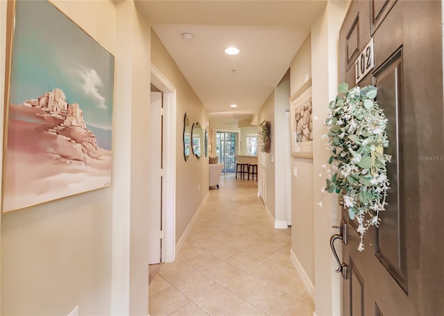 corridor with light tile patterned flooring