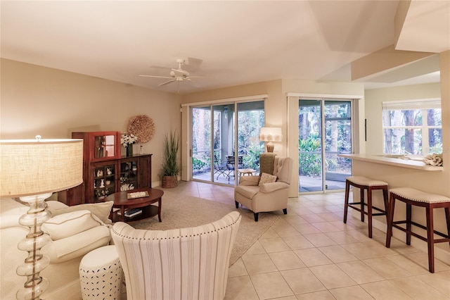 tiled living room with ceiling fan