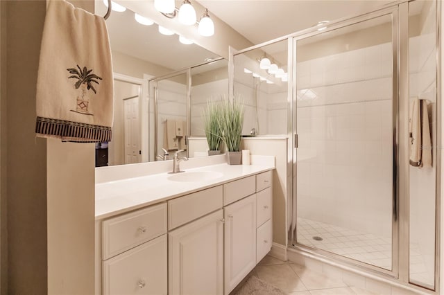 bathroom featuring vanity, an enclosed shower, and tile patterned floors