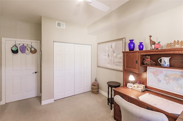 home office with light carpet and ceiling fan