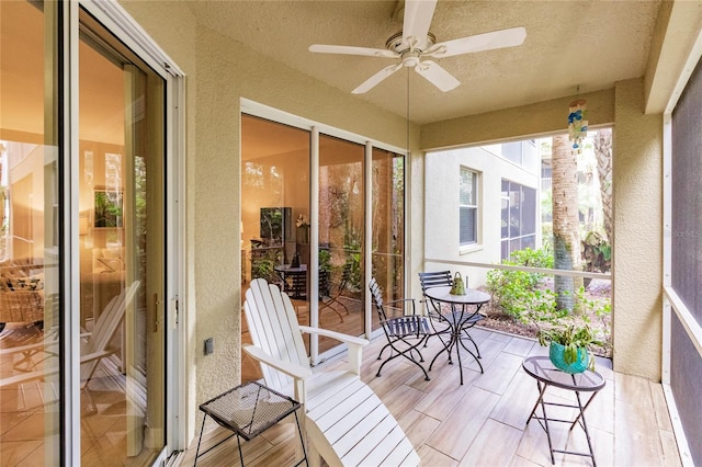 sunroom / solarium featuring ceiling fan