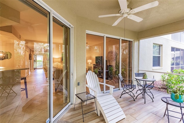 sunroom featuring ceiling fan