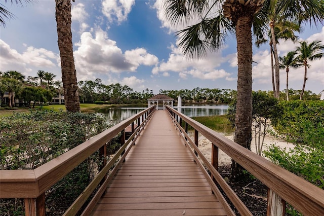 view of dock with a gazebo and a water view