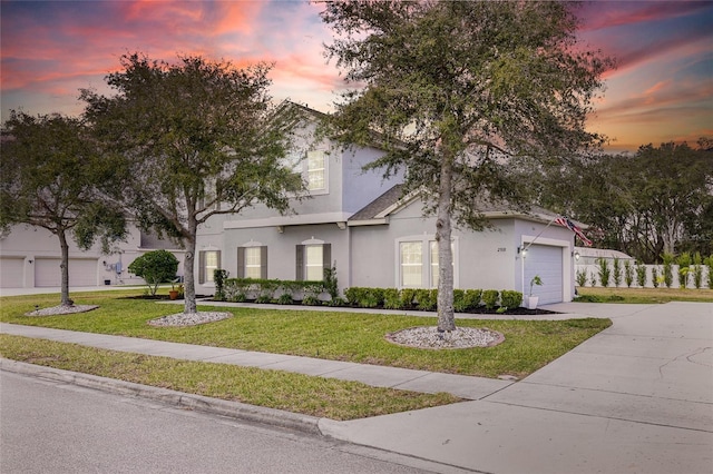 view of front facade with a lawn and a garage