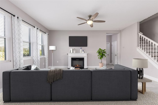 living room featuring ceiling fan and light tile patterned floors