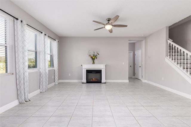 unfurnished living room with ceiling fan and light tile patterned floors