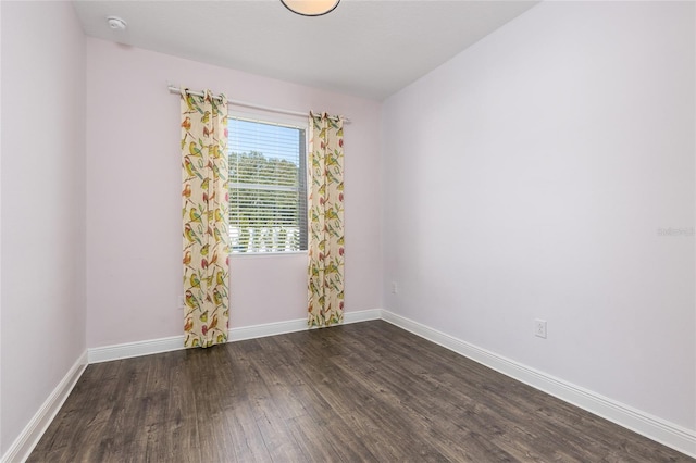 spare room with dark wood-type flooring