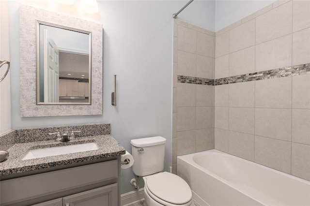 full bathroom with toilet, tiled shower / bath, and vanity