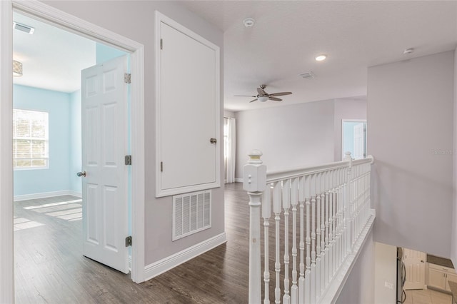 hall with hardwood / wood-style flooring